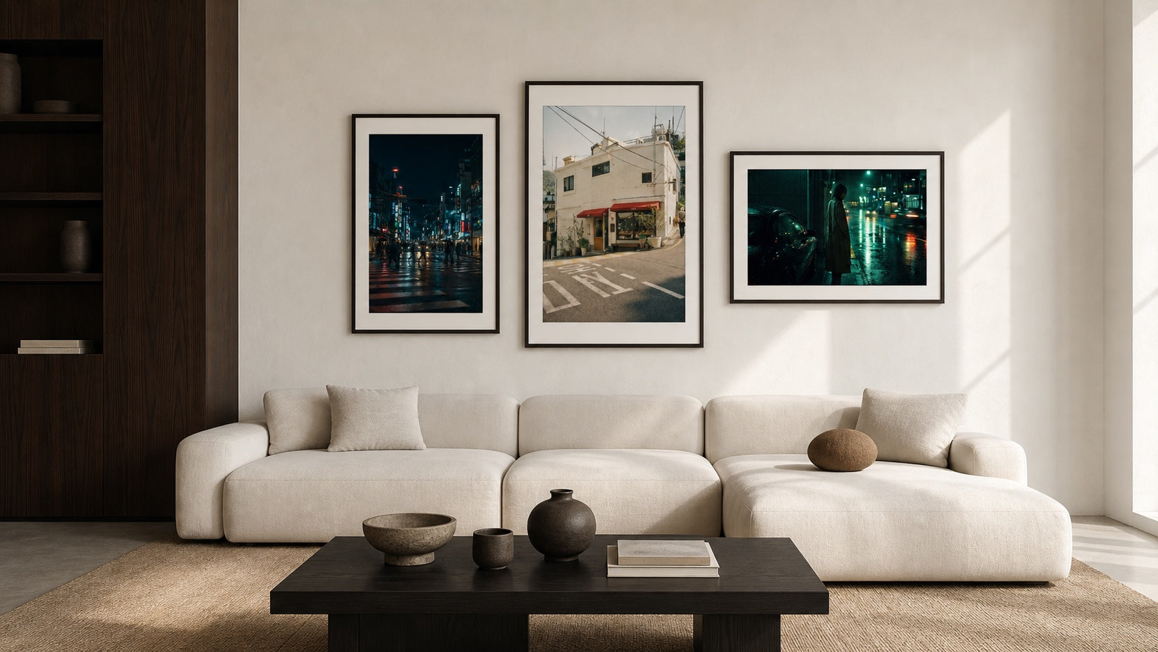 Three Seji cinematic prints arranged above a modern living room sofa
